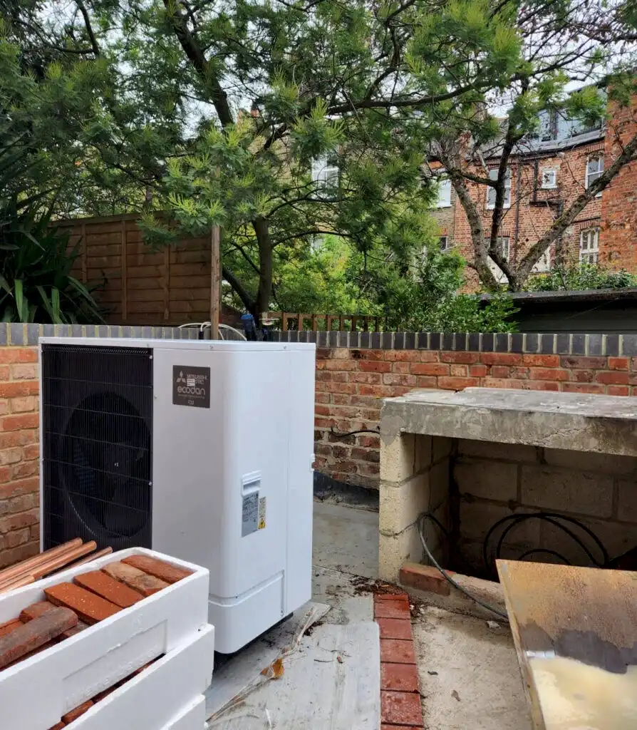 An Air Source Heat Pump will be installed in the rear patio with a cedar clad enclosure to conceal the unit