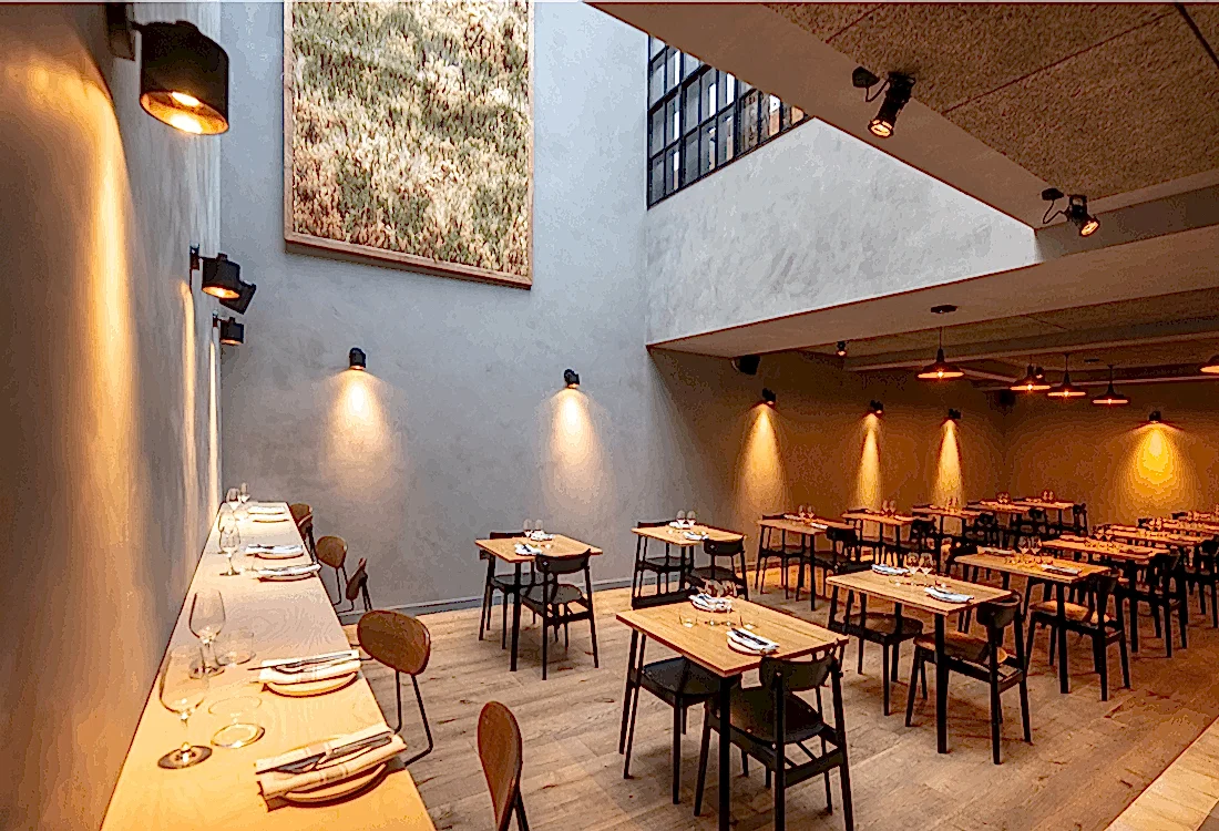 Modern dining space with minimalist design, natural lighting, and thoughtfully spaced tables, showcasing how cultural venues have adapted to post-pandemic priorities of comfort, safety, and aesthetic innovation.