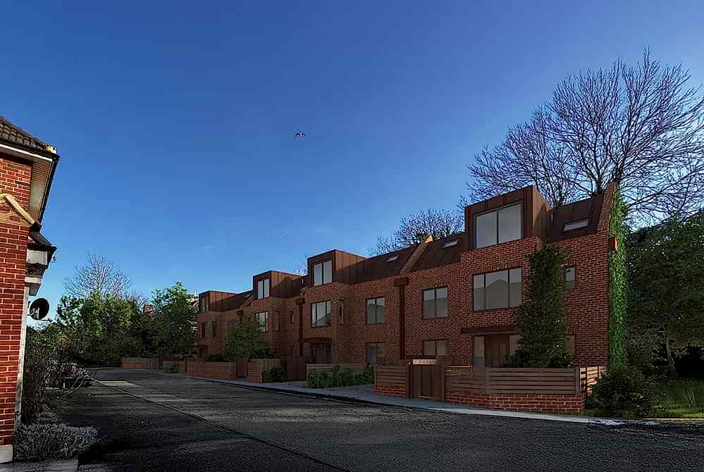 A street view of a modern small-site residential development in London by RISE Design Studio, featuring brick façades, generous glazing, copper-clad dormers, and landscaped front gardens that integrate seamlessly with the surrounding urban fabric.