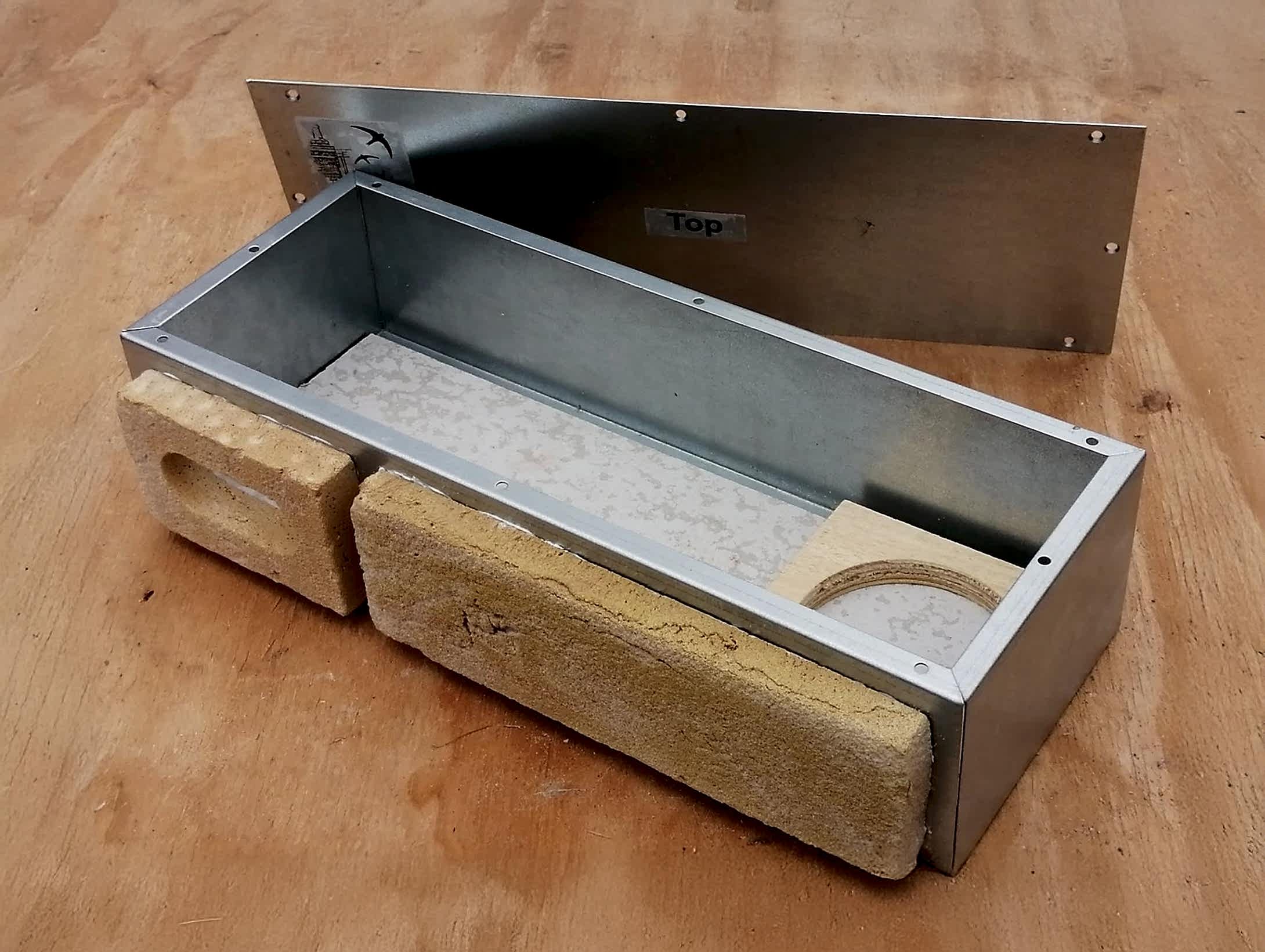 Built-in swift nest brick with removable cover, designed for seamless integration into external walls. Provides a safe, sustainable nesting site for swifts and other cavity-nesting birds as part of eco-conscious architectural design by RISE Design Studio.
